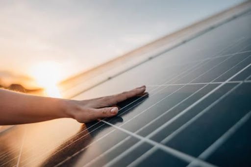 A hand on solar panels