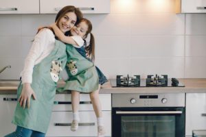 A mother and daughter in a kitchen 